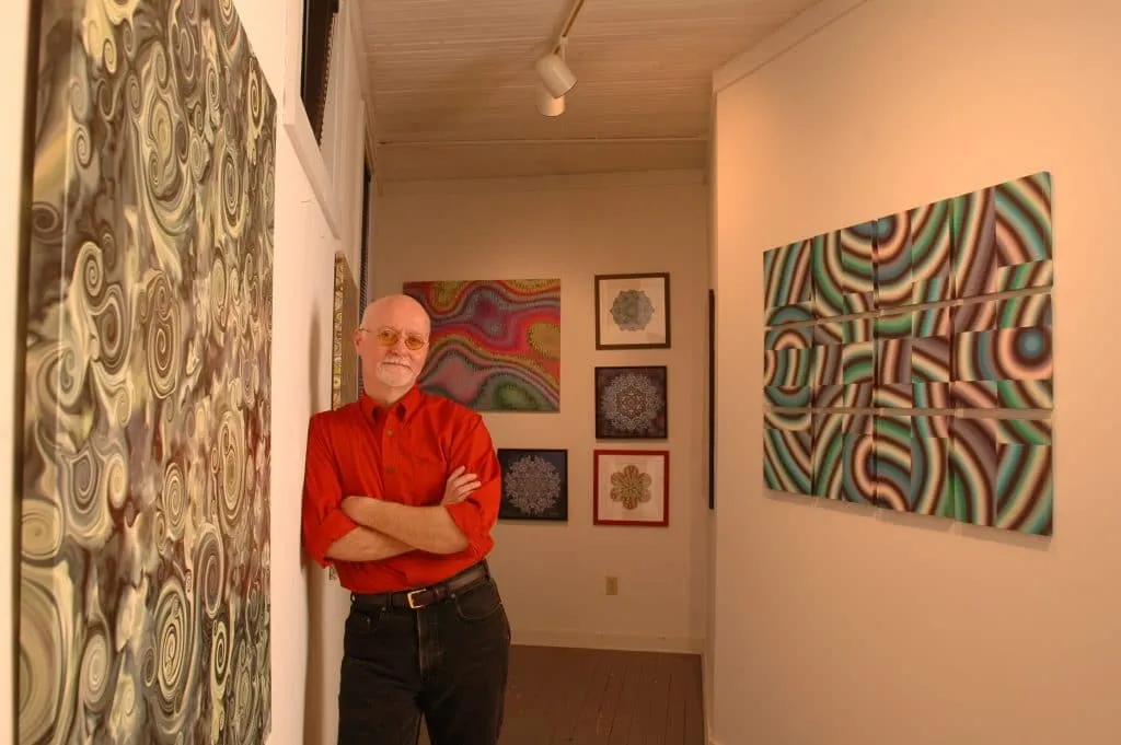 Potter demonstrating ceramics wheel technique to engaged classroom of children