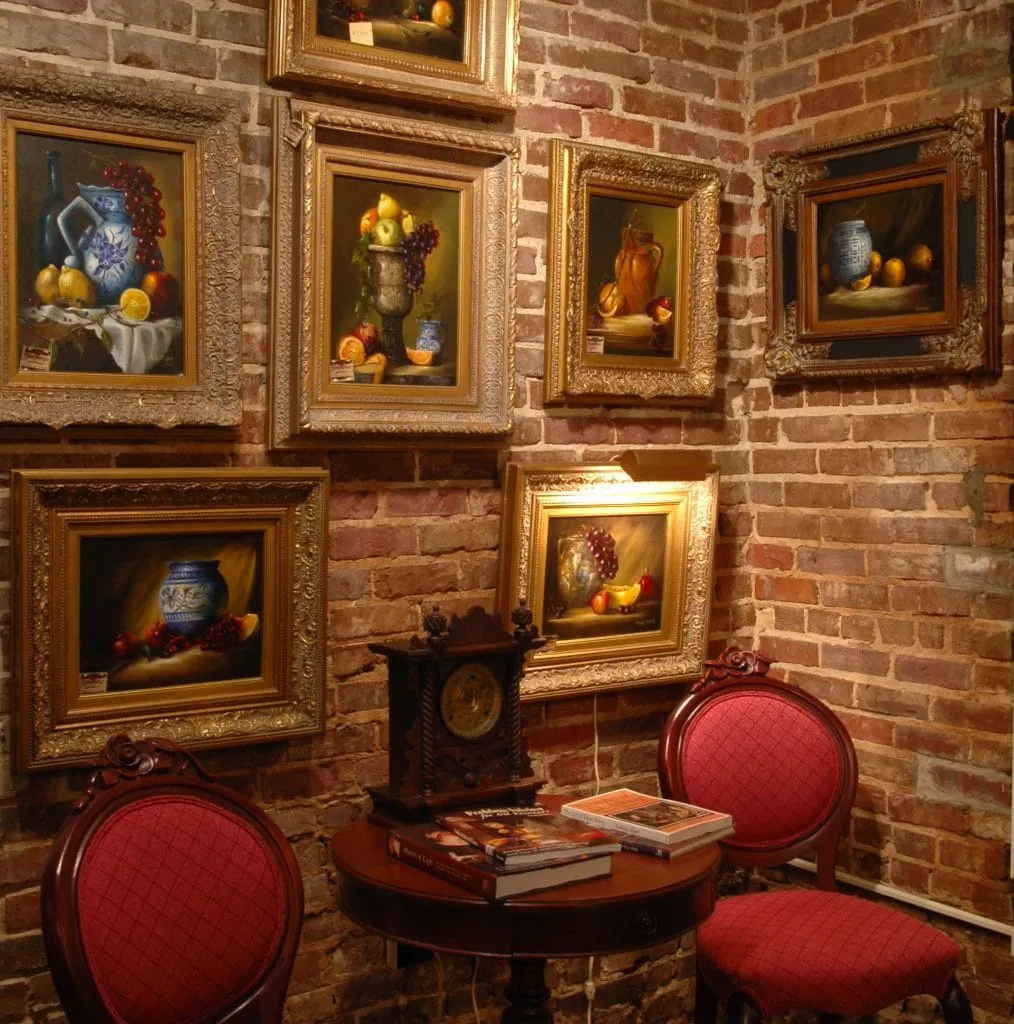 Whimsical bronze creature sculpture with horned features in outdoor setting